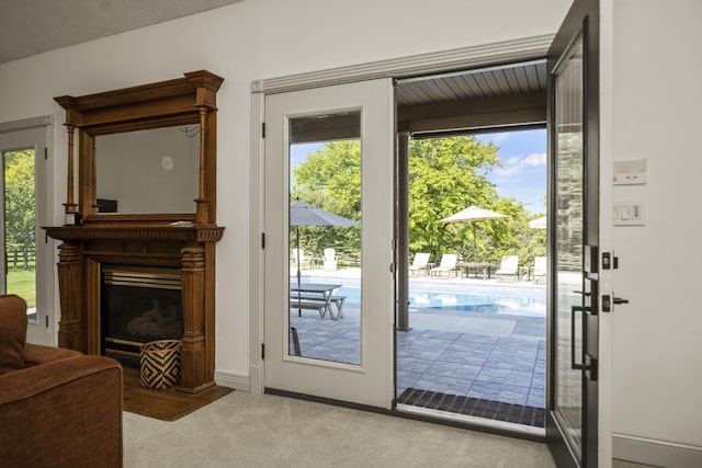 entryway featuring carpet flooring and a fireplace