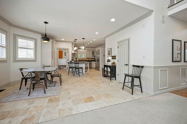 dining room featuring crown molding and light colored carpet