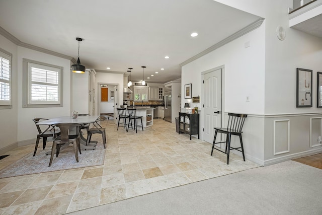 dining area featuring recessed lighting, a wainscoted wall, crown molding, and baseboards