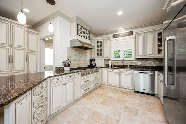 kitchen with dark stone counters, backsplash, appliances with stainless steel finishes, sink, and light tile patterned flooring