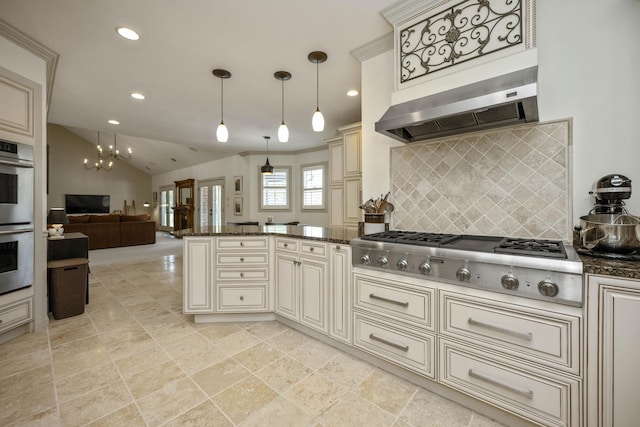 kitchen with cream cabinets, ventilation hood, stainless steel appliances, and open floor plan