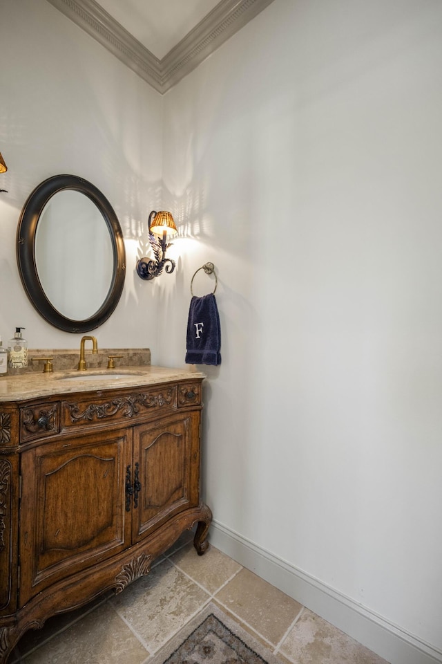 bathroom with baseboards, vanity, and crown molding