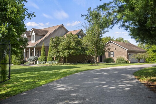 view of front of house with a front yard and a garage