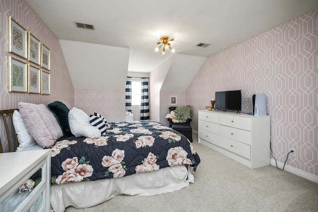 bedroom with light colored carpet, visible vents, vaulted ceiling, and wallpapered walls