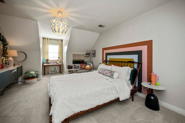 bedroom featuring carpet flooring, lofted ceiling, and a chandelier