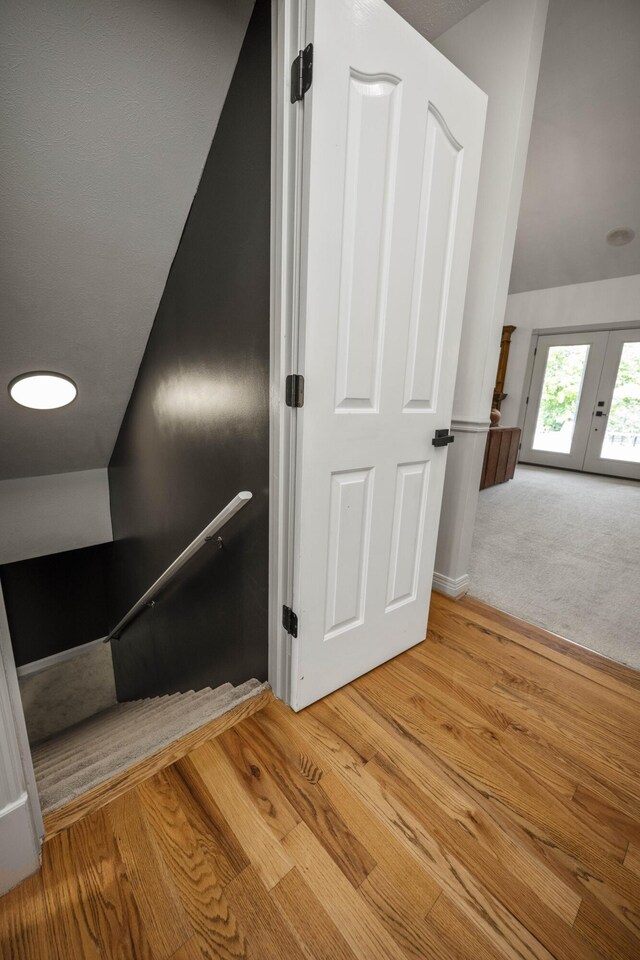 interior space with carpet, vaulted ceiling, and french doors