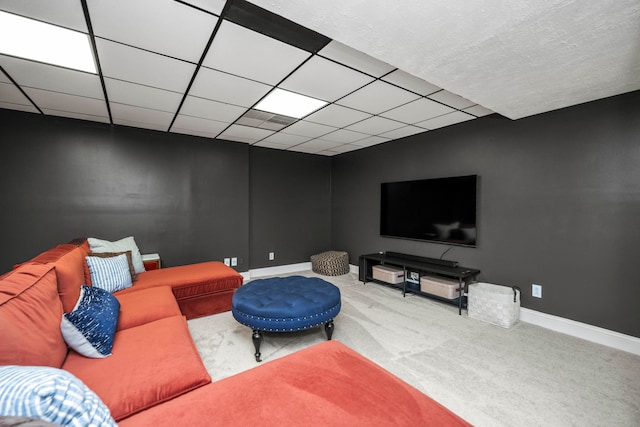 living room with carpet flooring and a paneled ceiling