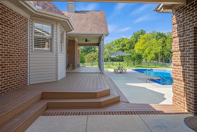 wooden terrace with a fenced in pool