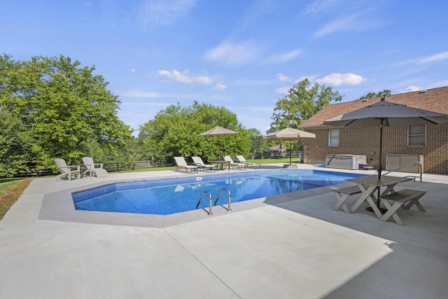 pool with a patio and fence