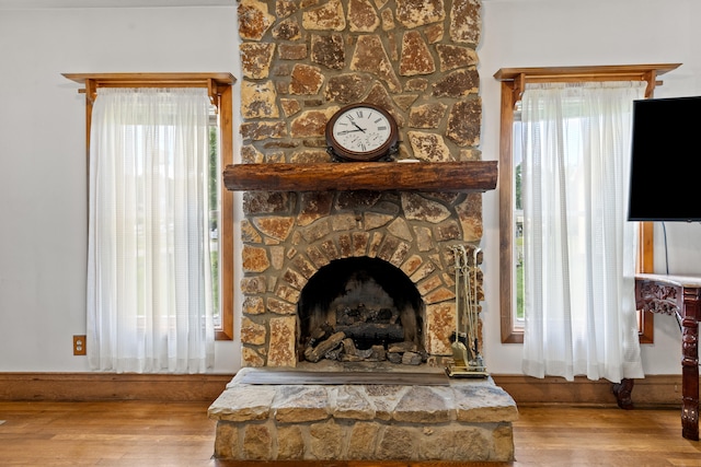 interior details featuring wood-type flooring and a fireplace