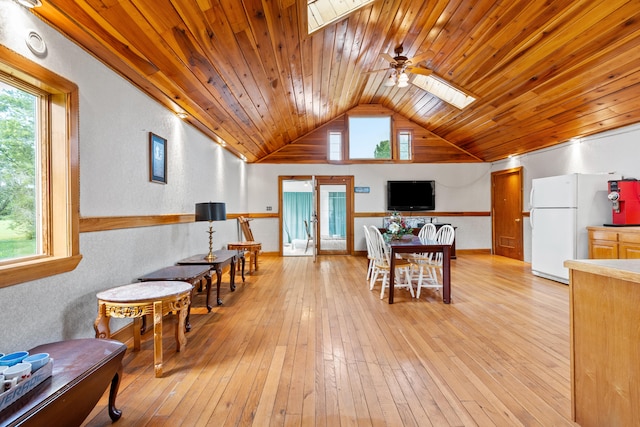 interior space with light wood-type flooring, french doors, ceiling fan, white fridge, and wood ceiling