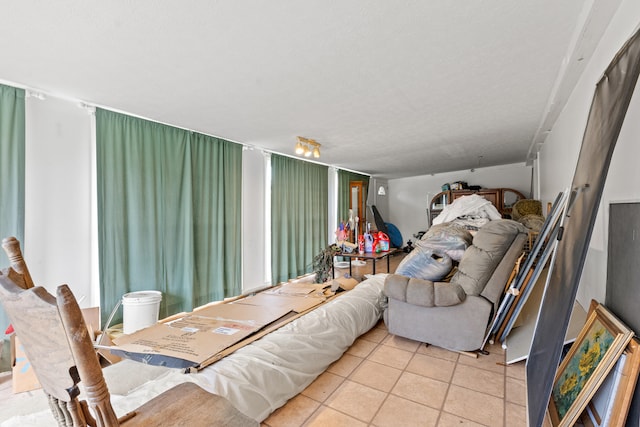 tiled living room featuring a textured ceiling