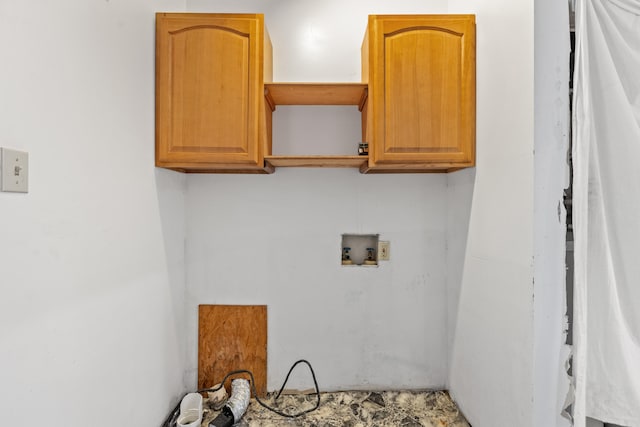 clothes washing area with cabinets and washer hookup