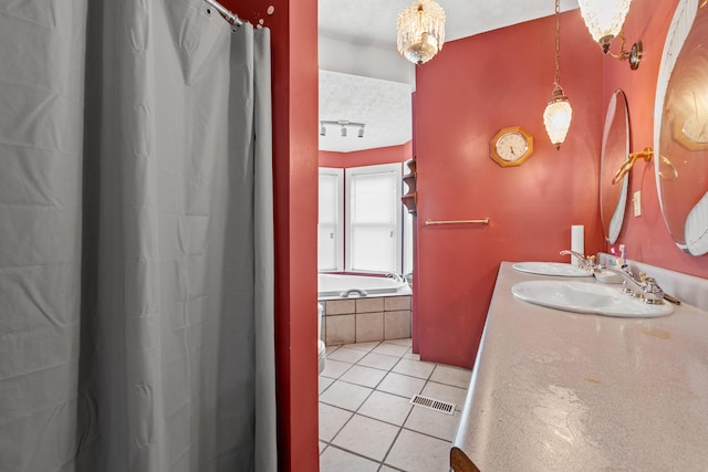 bathroom featuring vanity, a textured ceiling, shower / bath combination with curtain, and tile patterned flooring