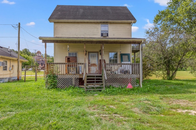 back of property featuring a lawn and a porch