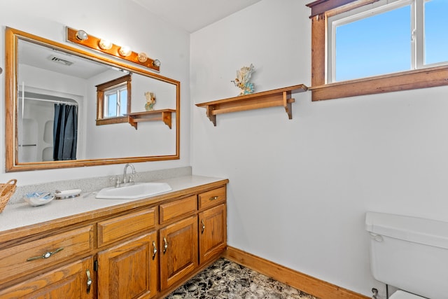 bathroom featuring tile patterned floors, vanity, and toilet