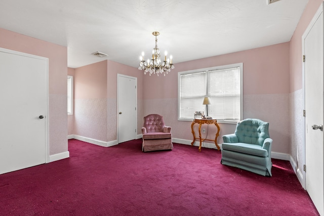 living area featuring carpet flooring and an inviting chandelier