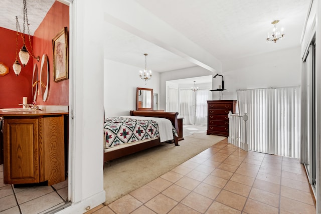 tiled bedroom featuring beamed ceiling, sink, and a chandelier