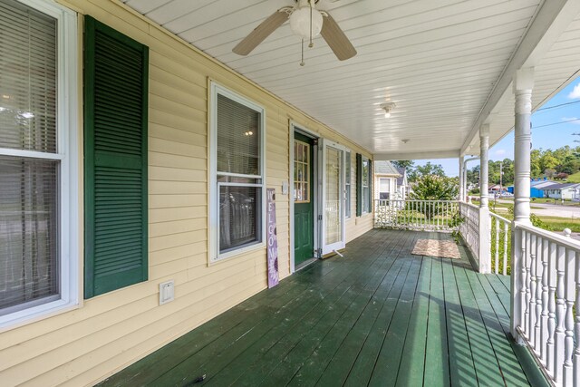 wooden terrace featuring ceiling fan