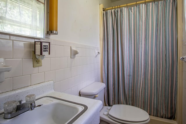 bathroom with tasteful backsplash, sink, tile walls, and toilet