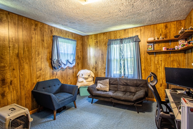 living room with carpet flooring, a textured ceiling, and wooden walls