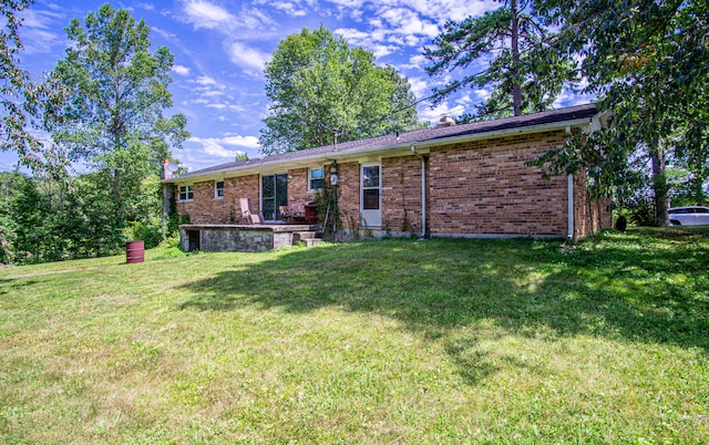 rear view of property with a yard