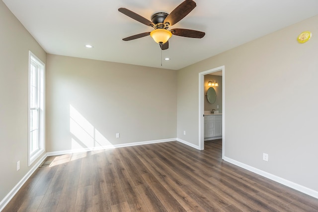 spare room with ceiling fan and dark hardwood / wood-style flooring