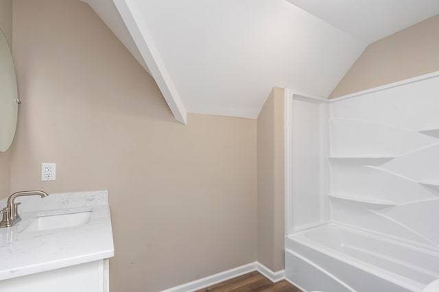 bathroom featuring vanity, vaulted ceiling, shower / tub combination, and hardwood / wood-style flooring