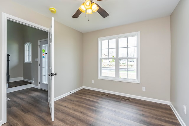 empty room featuring ceiling fan and dark hardwood / wood-style floors