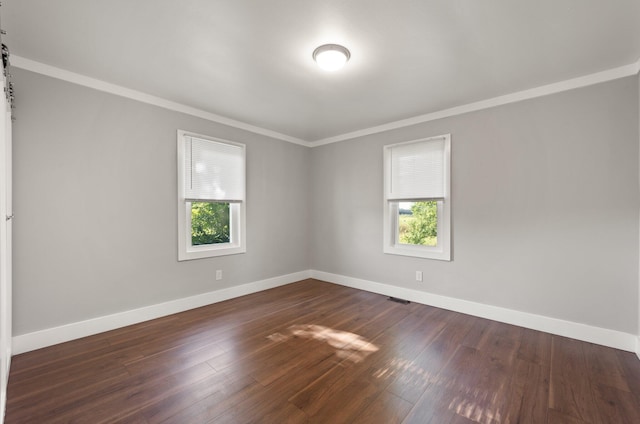 spare room with dark hardwood / wood-style floors and ornamental molding