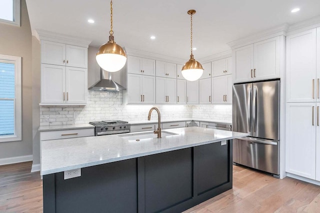 kitchen featuring tasteful backsplash, light stone countertops, stainless steel appliances, and light hardwood / wood-style floors