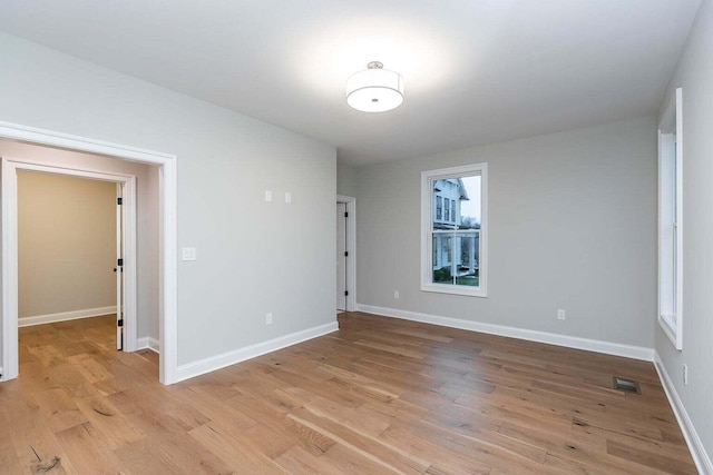 spare room featuring light hardwood / wood-style flooring