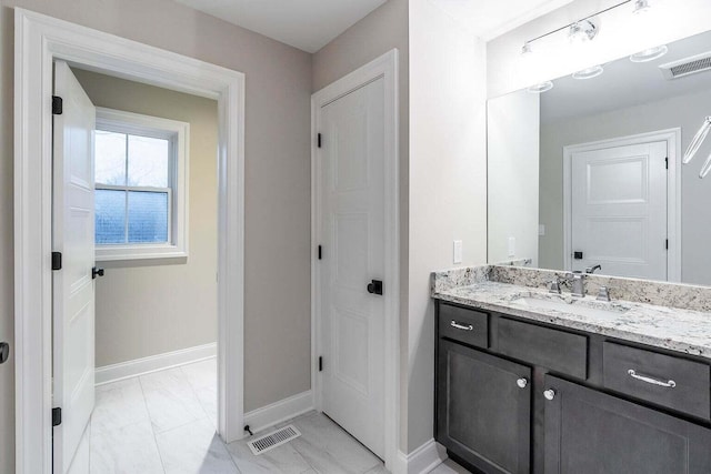 bathroom with tile patterned floors and vanity