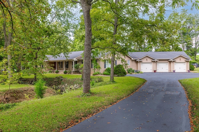 ranch-style house featuring a garage and a front yard