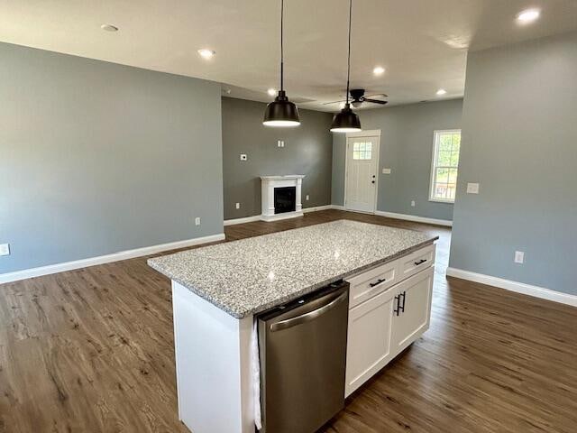 kitchen featuring white cabinetry, stainless steel dishwasher, dark hardwood / wood-style flooring, a center island, and ceiling fan