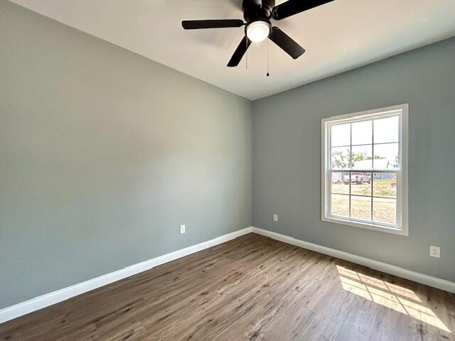 spare room featuring hardwood / wood-style floors and ceiling fan