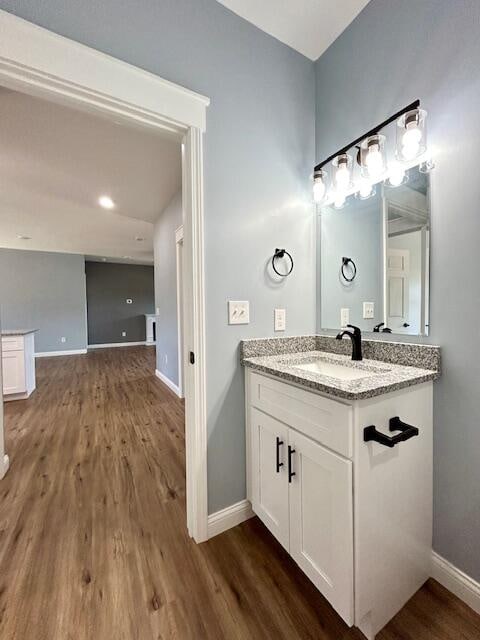 bathroom with vanity and wood-type flooring