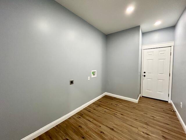 interior space featuring washer hookup, electric dryer hookup, and wood-type flooring