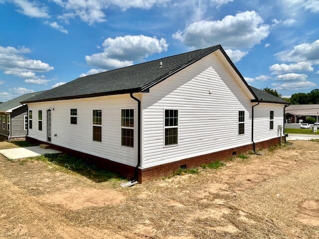 view of home's exterior with crawl space