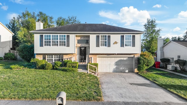 split foyer home with a front lawn and a garage