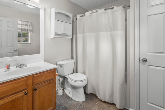 bathroom featuring tile patterned floors, vanity, and toilet