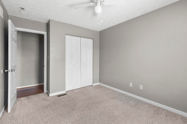 unfurnished bedroom with a closet, ceiling fan, and carpet floors