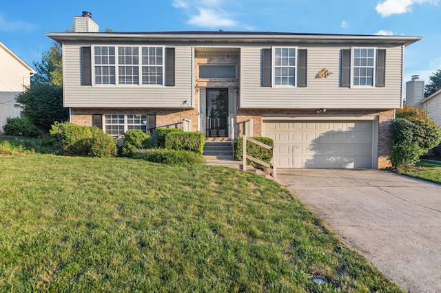 raised ranch with a front yard and a garage