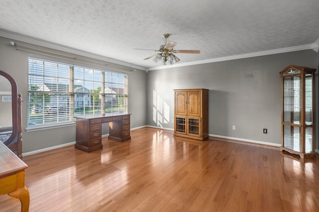 interior space with ceiling fan, a textured ceiling, crown molding, and hardwood / wood-style flooring