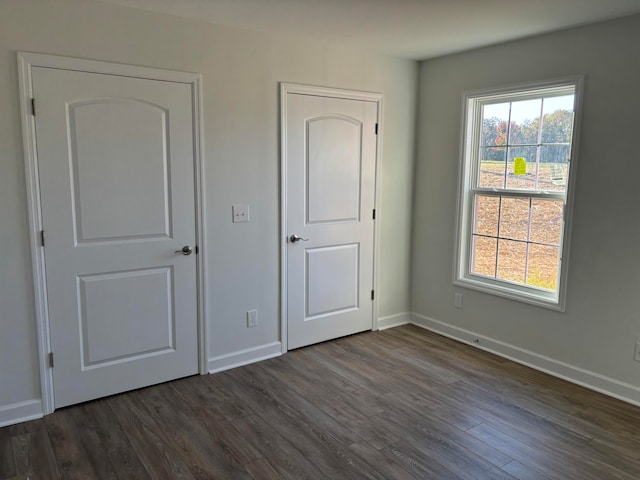 unfurnished bedroom featuring dark hardwood / wood-style flooring