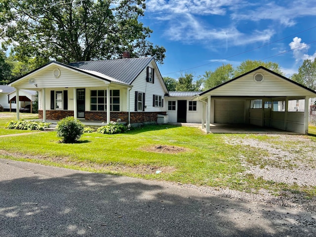 view of front of house with a garage, a carport, covered porch, and a front yard