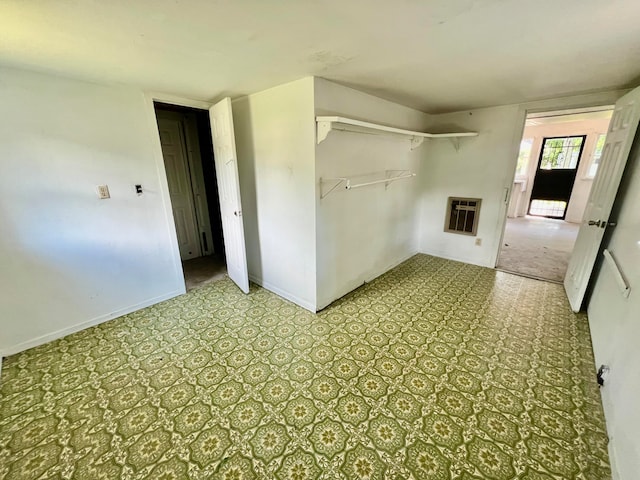 laundry area featuring light carpet