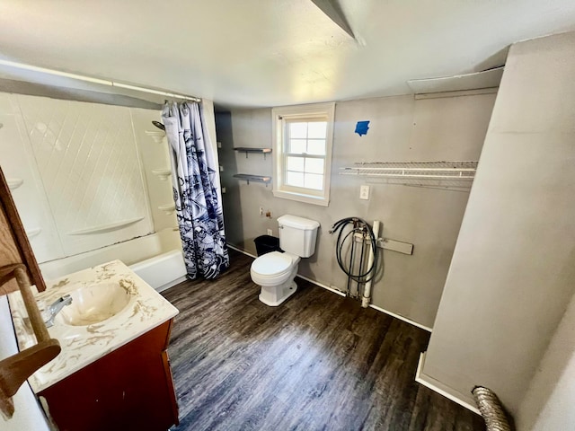 full bathroom with hardwood / wood-style flooring, shower / tub combo with curtain, vanity, and toilet