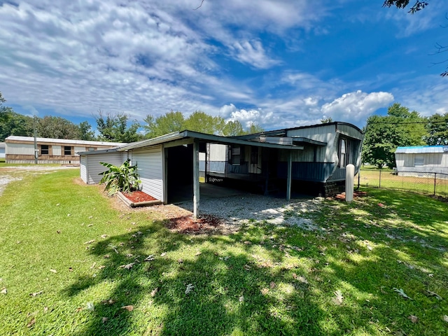 back of house with a lawn