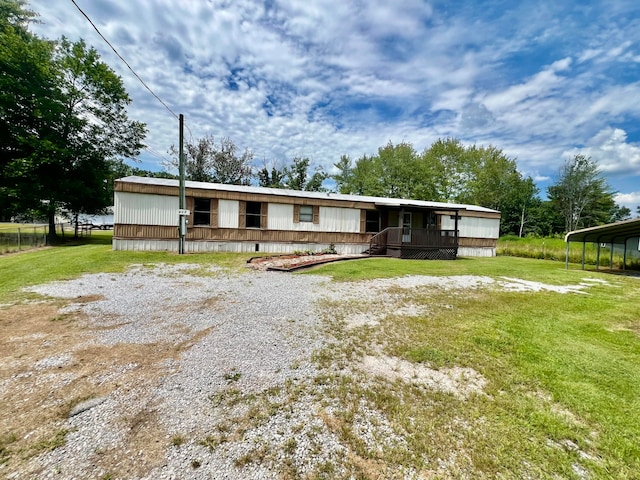 manufactured / mobile home with a carport and a front lawn